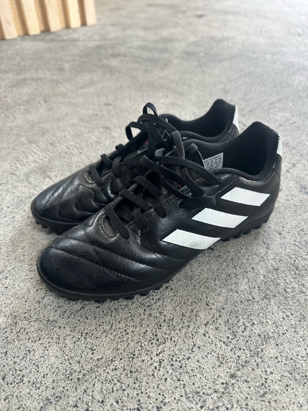 Kids Adidas Black Soccer Cleats with White Stripes